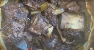 Braised short ribs with vegetables in a savory sauce, featuring tender, fall-off-the-bone beef goodness.